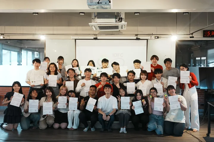 A group photo of IDFC2026 participants holding certificates