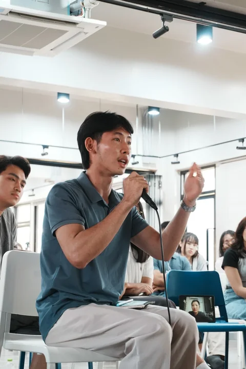 A speaker using a microphone at IDFC2026