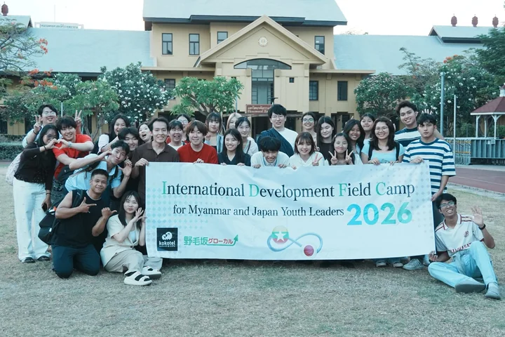 IDFC2026 participants gathered around the conference banner