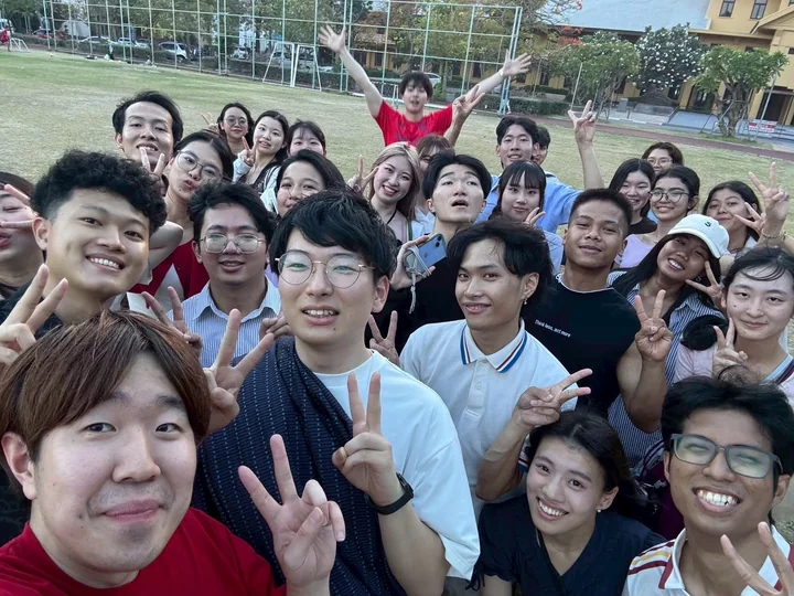 IDFC2026 participants taking a group selfie outdoors