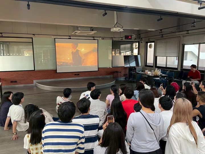 IDFC2026 participants watching a presentation on a screen